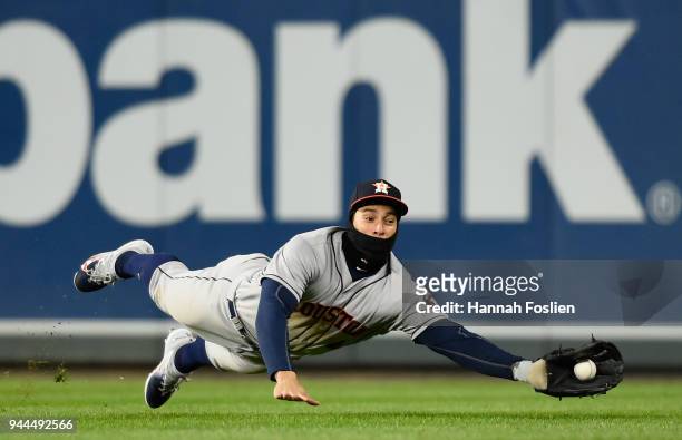 George Springer of the Houston Astros makes a catch of the ball hit by Byron Buxton of the Minnesota Twins during the eighth inning of the game on...