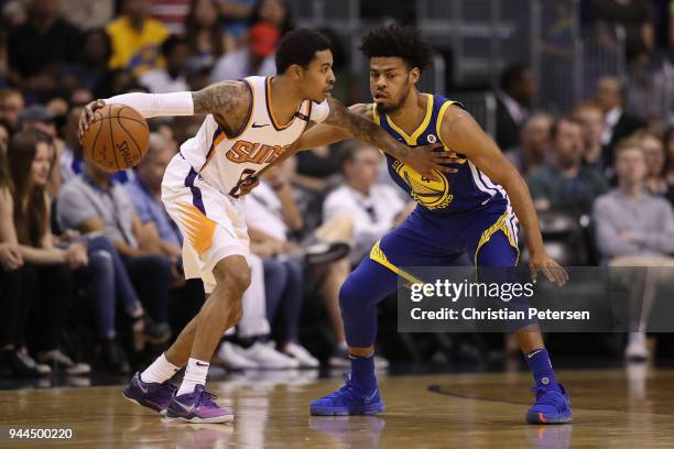 Tyler Ulis of the Phoenix Suns handles the ball under pressure from Quinn Cook of the Golden State Warriors during the first half of the NBA game at...