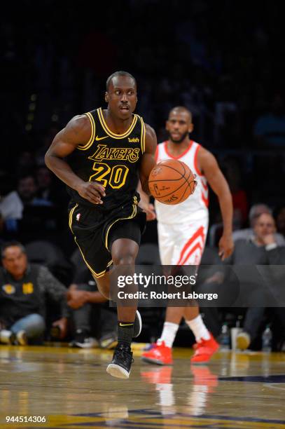 Andre Ingram of the Los Angeles Lakers dribbles the ball as Chris Paul of the Houston Rockets looks on, on April 10, 2018 at STAPLES Center in Los...