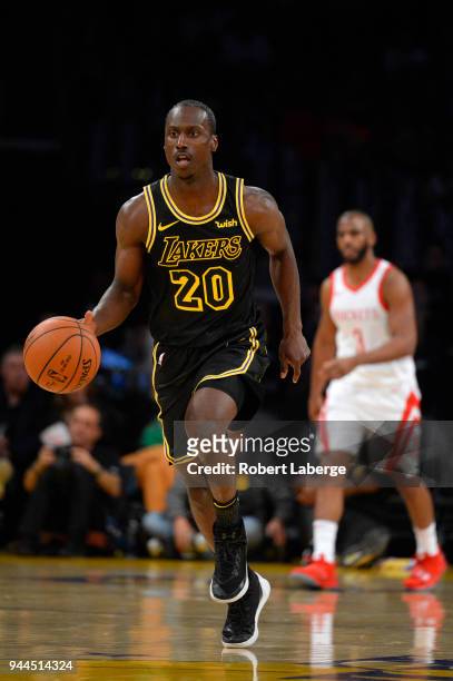 Andre Ingram of the Los Angeles Lakers dribbles the ball as Chris Paul of the Houston Rockets looks on, on April 10, 2018 at STAPLES Center in Los...