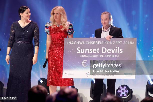 Lina van de Mars, German presenter Barbara Schoeneberger and award winner Andreas Illenseer during the German Computer Games Award 2018 at Kesselhaus...