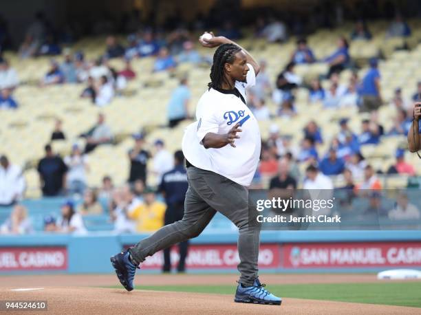 Player Todd Gurley throws out the first pitch at The Los Angeles Dodgers Game at Dodger Stadium on April 10, 2018 in Los Angeles, California.