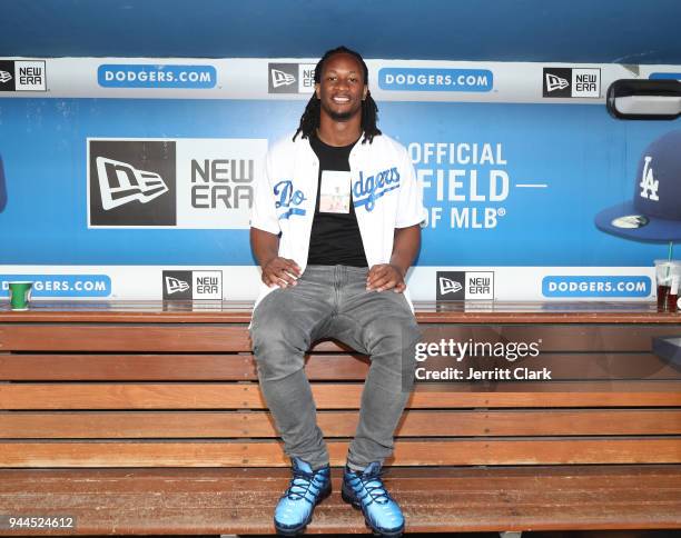 Player Todd Gurley poses for a photo in the Dodgers dugout prior to throwing out the first pitch at The Los Angeles Dodgers Game at Dodger Stadium on...