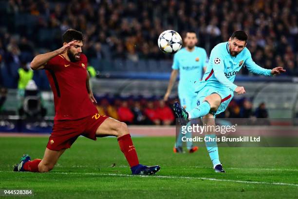 Lionel Messi of FC Barcelona takes a shot as Federico Fazio of AS Roma attempts to block during the UEFA Champions Leagues Quarter Final, second leg...