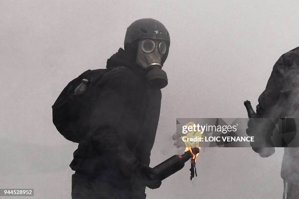 Protester prepares to throw a Molotov cocktail at riot forces as clashes erupt during a police operation to raze the decade-old camp known as ZAD at...