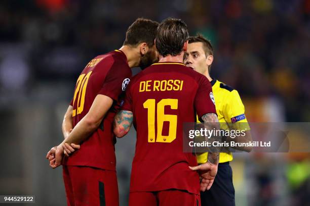 Daniele De Rossi and Federico Fazio both of AS Roma talk with Referee Clement Turpin during the UEFA Champions League Quarter Final, second leg match...