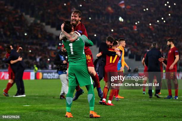 Alisson of AS Roma celebrates victory with teammate Daniele De Rossi after the UEFA Champions League Quarter Final, second leg match between AS Roma...