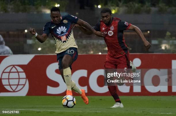 Alex Ibarra of America and Ashton Morgan of Toronto fight for the ball during the semifinal second leg match between America and Toronto at Azteca...