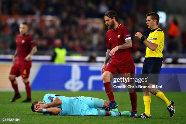 Luis Suarez of FC Barcelona reacts to a challenged as Daniele De Rossi of AS Roma looks on during the UEFA Champions League Quarter Final, second leg...
