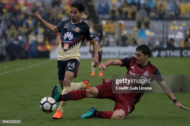 Diego Lainez of America dribbles Marky Delgado of Toronto during the semifinal second leg match between America and Toronto at Azteca Stadium on...