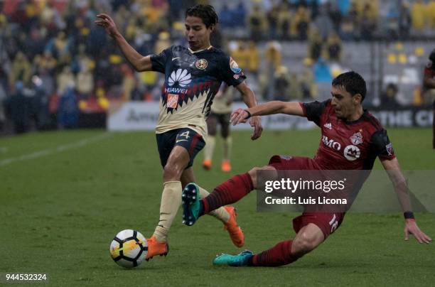 Diego Lainez of America dribbles Marky Delgado of Toronto during the semifinal second leg match between America and Toronto at Azteca Stadium on...