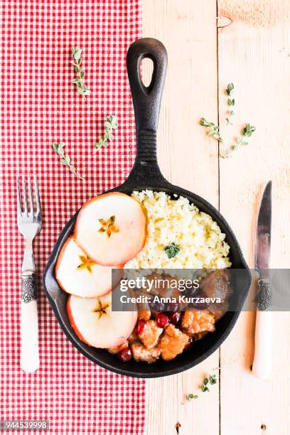 pork stew with dried cranberry served with couscous in a pan, selective focus - homemade apple sauce stock pictures, royalty-free photos & images