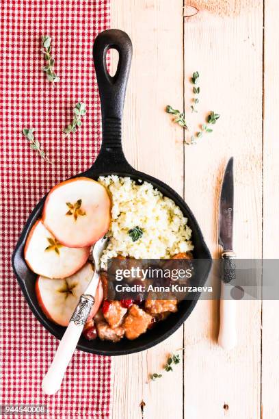 pork stew with dried cranberry served with couscous in a pan, selective focus - homemade apple sauce stock pictures, royalty-free photos & images