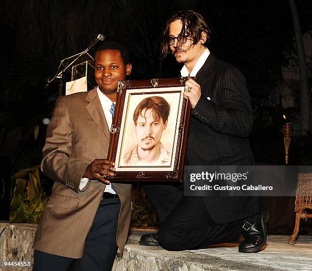 Bahamian Artist presents actor Johnny Depp with his painting at the 6th Annual Bahamas Film Festival special tribute and presentation at the Balmoral...