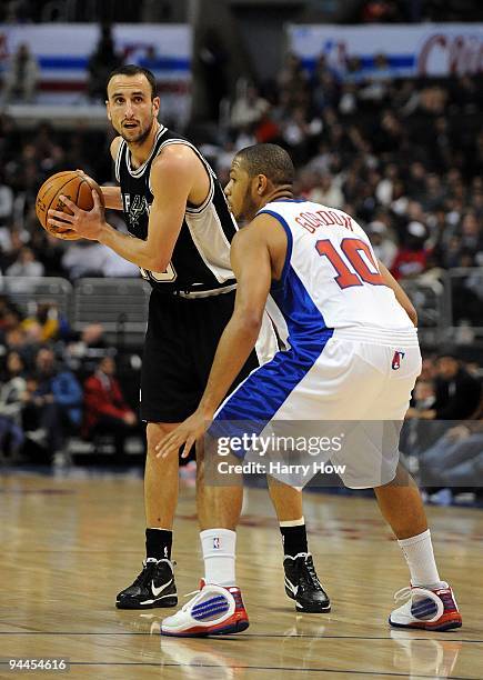 Manu Ginobili of the San Antonio Spurs waits to pass in front of Eric Gordon of the Los Angeles Clippers at Staples Center on December 13, 2009 in...