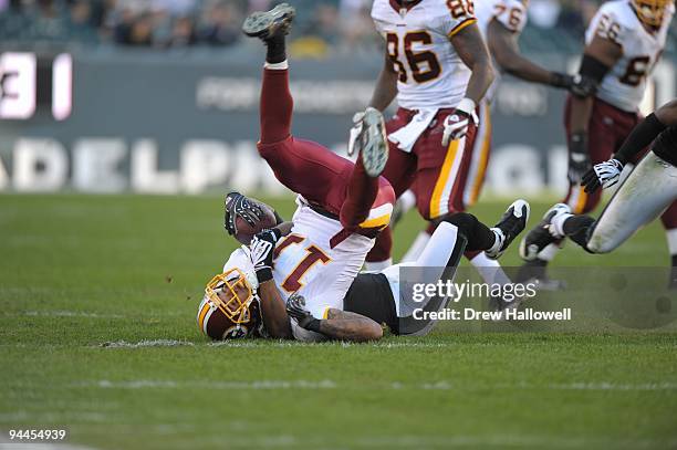 Cornerback Sheldon Brown of the Philadelphia Eagles tackles wide receiver Devin Thomas of the Washington Redskins on November 29, 2009 at Lincoln...