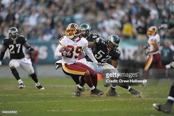 Wide receiver Santana Moss of the Washington Redskins evades linebacker Tracy White of the Philadelphia Eagles on November 29, 2009 at Lincoln...