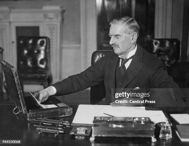 British statesman Neville Chamberlain , Chancellor of the Exchequer, prepares his budget, 1937.