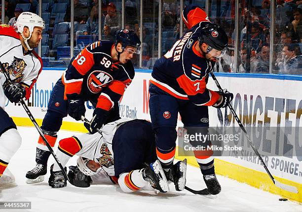 Trent Hunter of the New York Islanders gets held by the skates of a Florida Panther on December 14, 2009 at Nassau Coliseum in Uniondale, New York.