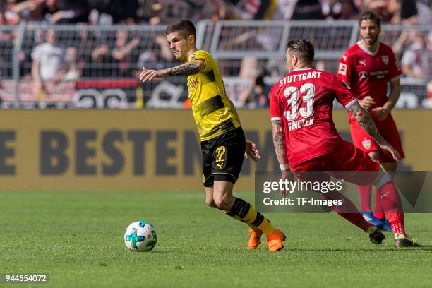Christian Pulisic of Dortmund and Daniel Ginczek of Stuttgart battle for the ball during the Bundesliga match between Borussia Dortmund and VfB...