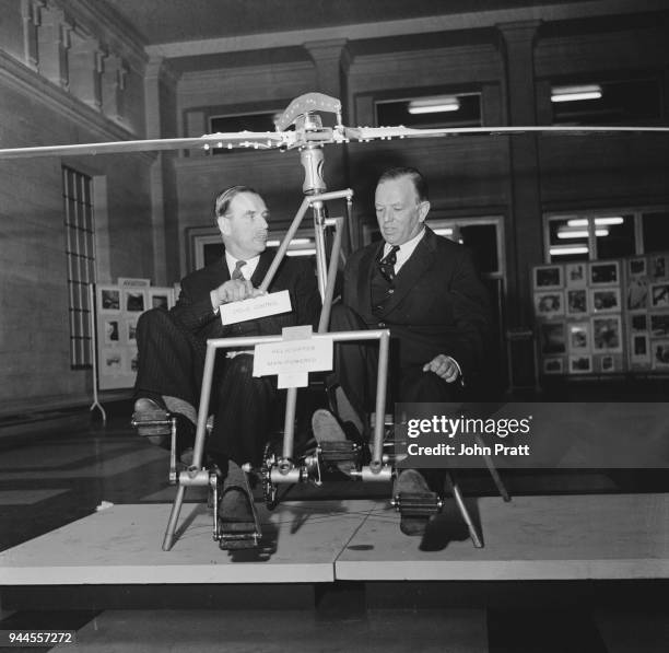 Air Marshal Sir Walter Cheshire of the RAF and Sir Maurice Dean , Permanent Under-Secretary of state for Air, try out a new man-powered helicopter...