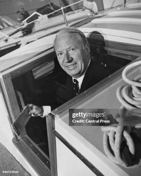 British Conservative politician Edward Heath , Leader of the Opposition, emerges from the cabin of a yacht at the International Boat Show at Earl's...