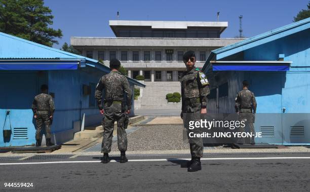 South Korean soldiers stand guard before the military demarcation line during a press tour to the border truce village of Panmunjom in the...