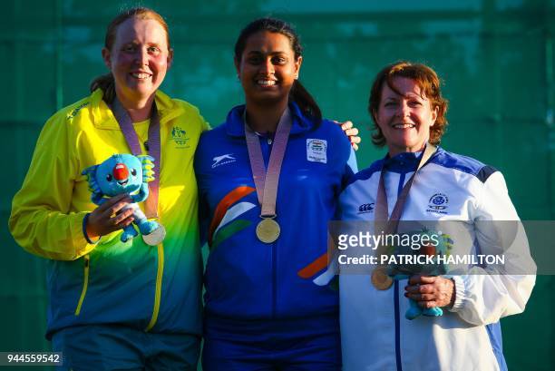Australia's Emma Cox, India's Shreyasi Singh and Scotland's Linda Pearson pose on the podium during the medal ceremony for the women's double trap...