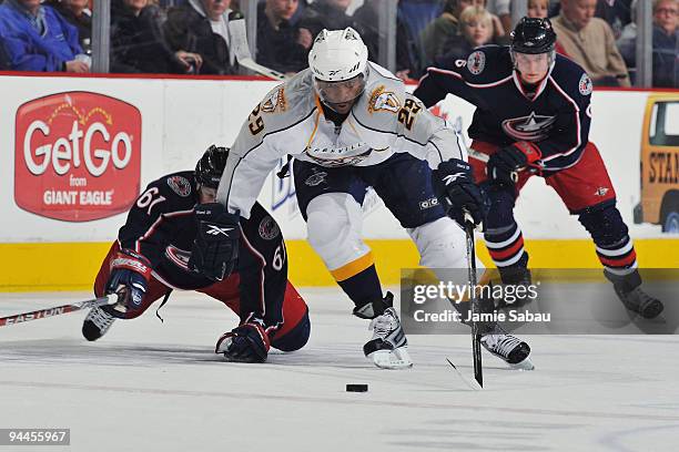 Joel Ward of the Nashville Predators skates away from Rick Nash of the Columbus Blue Jackets and Anton Stralman of the Columbus Blue Jackets during...