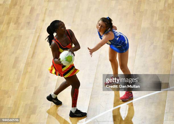 Ruth Meme of Uganda holds off Samantha Murphy of Scotland during the Netball Pool B match between Uganda and Scotland on day seven of the Gold Coast...