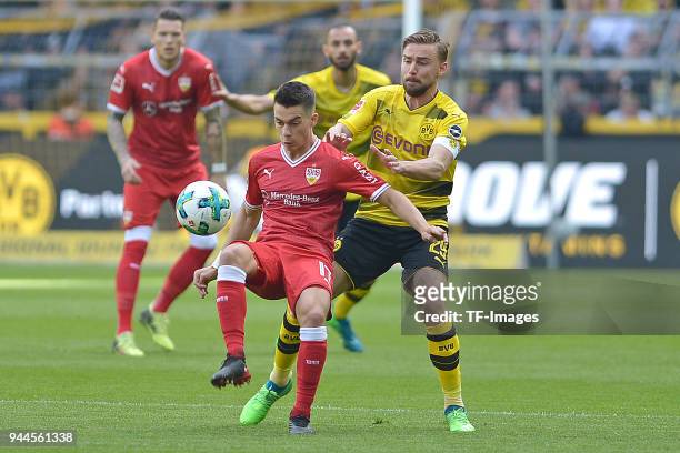Erik Thommy of Stuttgart and Marcel Schmelzer of Dortmund battle for the ball during the Bundesliga match between Borussia Dortmund and VfB Stuttgart...