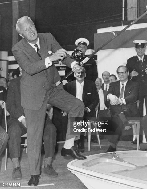 British Conservative politician Edward Heath , Leader of the Opposition, has trouble casting a line after opening the National Angling Show at the...