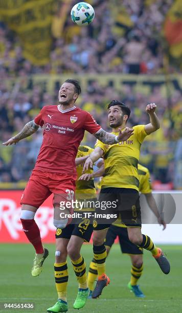 Daniel Ginczek of Stuttgart and Nuri Sahin of Dortmund battle for the ball during the Bundesliga match between Borussia Dortmund and VfB Stuttgart at...