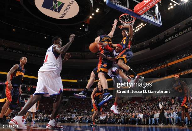 Allen Iverson of the Philadelphia 76ers passes the ball against Vladimir Radmanovic and Anthony Randolph of the Golden State Warriors during the game...