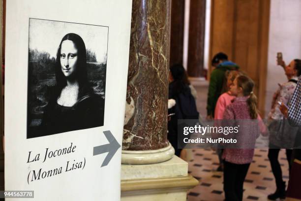 Visitors walk to see 'La Joconde', a 1503-1506 oil on wood portrait of Mona Lisa by Leonardo Da Vinci, at the Louvre Museum in Paris, on April 9,...