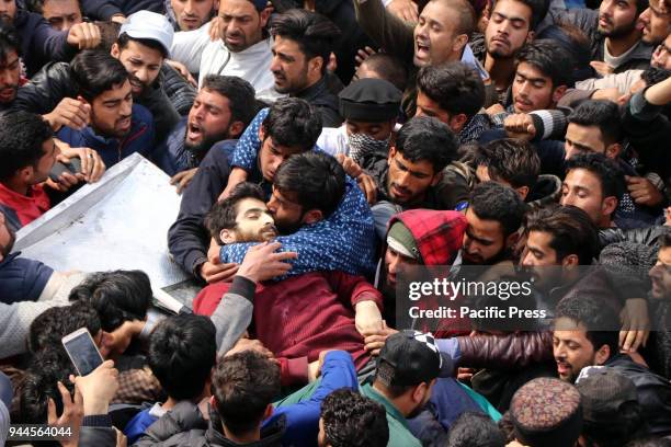 Man kisses the face of a rebel during the funeral precession of a rebel Eisa Fazili in Srinagar on March12, 2018. Indian government forces killed...