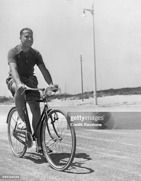 Italian Foreign Minister Galeazzo Ciano, 2nd Count of Cortellazzo and Buccari learns to ride a bicycle, circa 1940.