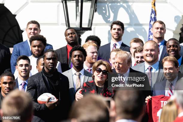 President Donald Trump , poses with Alabama Crimson Tide coach Nick Saban , his wife Terry Saban , and the team, at a celebration of their 2017 NCAA...