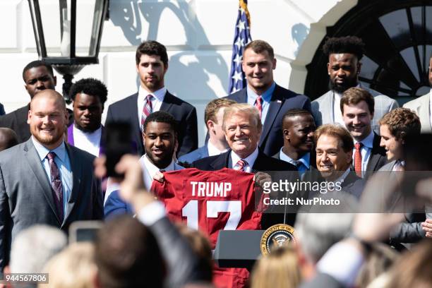 Alabama Crimson Tide players present U.S. President Donald Trump with a commemorative jersey with his name on it, at the White House celebration of...