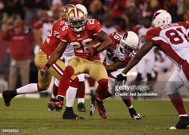 Mark Roman of the San Francisco 49ers runs after recovering a fumble by LaRod Stephens-Howling of the Arizona Cardinals in the first half at...