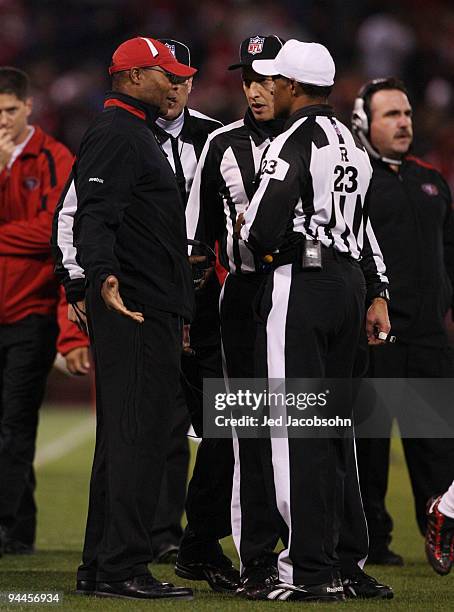 Head coach Mike Singletary of the San Francisco 49ers talks with the referees before throwing his second and last red challenge flag of the first...