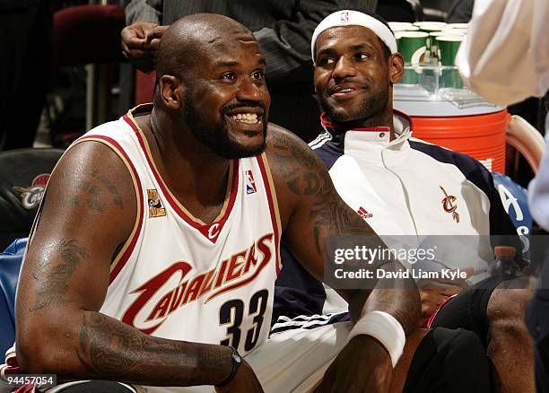 Shaquille O'Neal and LeBron James of the Cleveland Cavaliers smile as they take a rest on the bench during the game against the Chicago Bulls at...