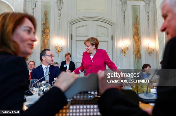 German Chancellor Angela Merkel takes her seat next to Foreign Minister Heiko Maas as German Justice Minister Katarina Barley and Interior Minister...