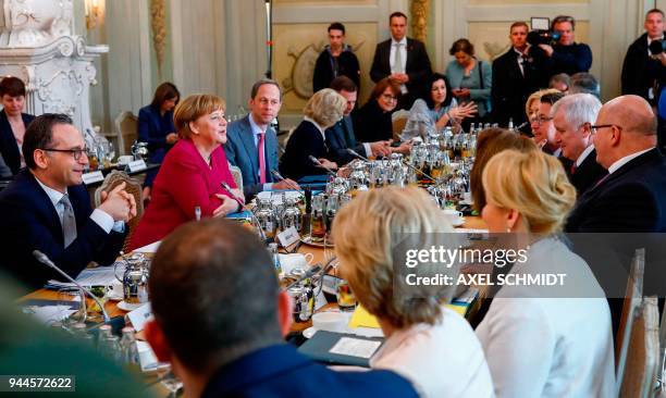 German Chancellor Angela Merkel sits next to German Foreign Minister Heiko Maas and among members of the government ahead of a cabinet meeting on...