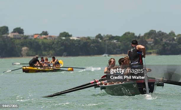 Members of the Warriors NRL team approach the finish line ahead of the Blues Super 14 team during the Surf Boat Duel between the Blues and the...