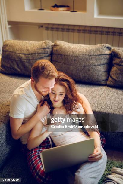 couple watching romantic movie on laptop - loving 2016 film stock pictures, royalty-free photos & images