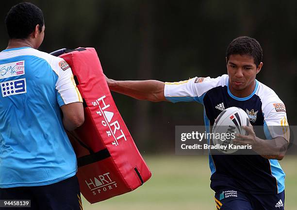 David Mead pushes away from the tackling pads during a Gold Coast Titans NRL training session at Robina on December 15, 2009 at the Gold Coast,...