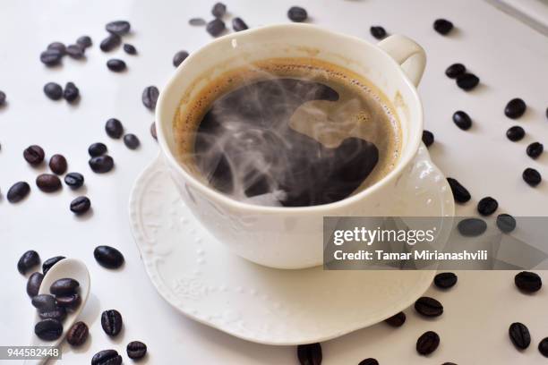 hot coffee with coffee beans - tamar mirianashvili stock-fotos und bilder