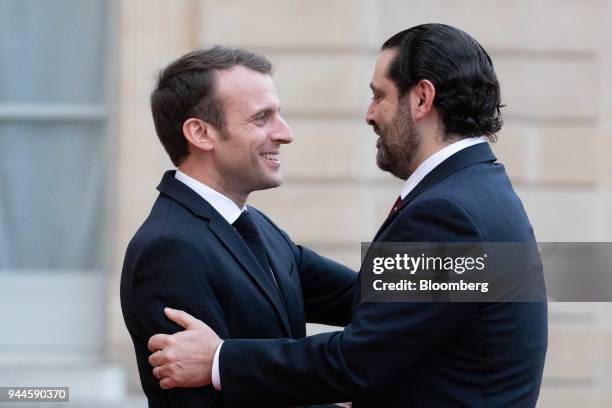 Emmanuel Macron, France's president, left, greets Saad al-Hariri, Lebanon's prime minister, as he arrives at the Elysee Palace ahead of a dinner with...