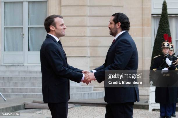 Emmanuel Macron, France's president, left, greets Saad al-Hariri, Lebanon's prime minister, as he arrives at the Elysee Palace ahead of a dinner with...